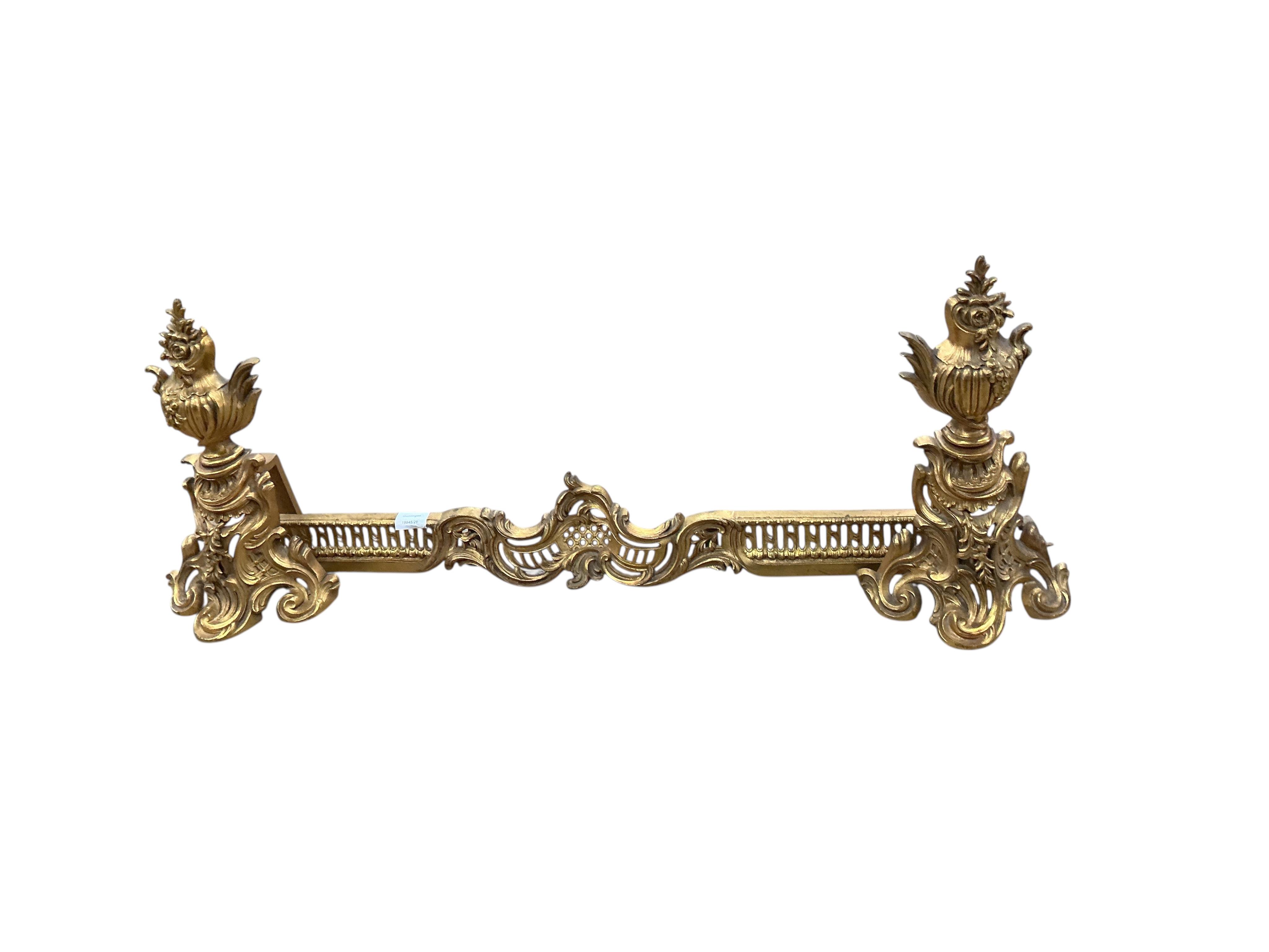 A late 19th century ormolu fender with chenets